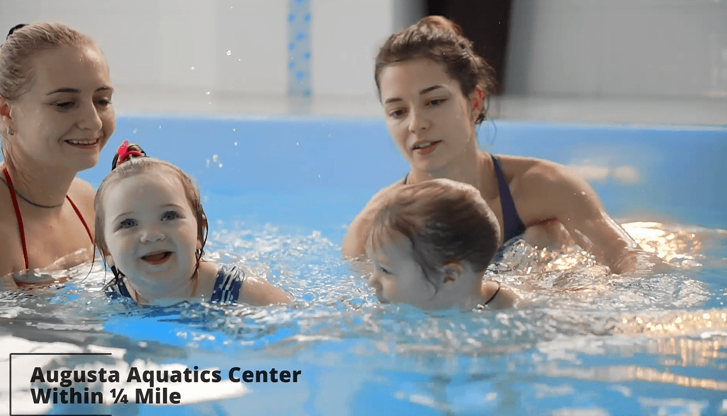 a family playing in the water in a swimming pool