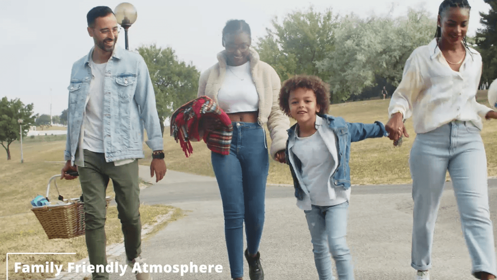 a family walking down the street holding hands