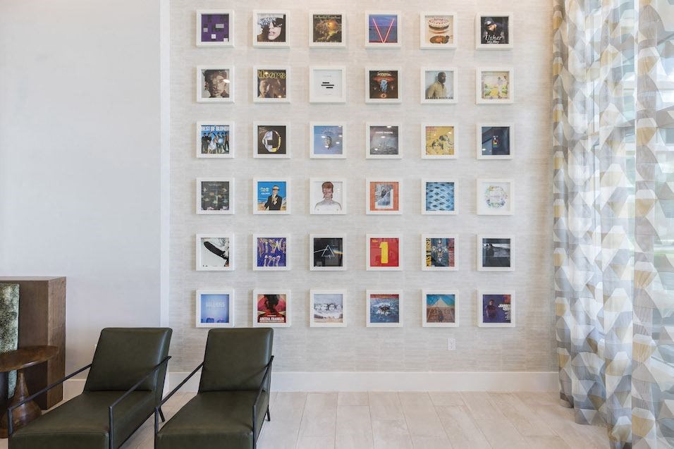 Lounge with vintage record albums on the wall at Residences at The Green