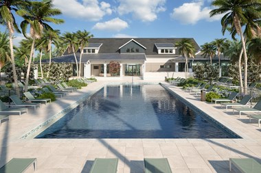 Large rectangular swimming pool with many lounge chairs and towering palms at Lake Nona Concorde, Florida