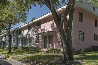Mature trees and neat sidewalks in front of pastel apartment homes Mature trees and neat sidewalks in front of pastel apartment homes at Terraces at Clearwater Beach, Clearwater - Photo Gallery