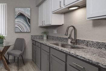 The kitchen in the model at Terraces at Clearwater Beach with shaker cabinets and granite countertops