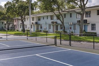 A Pickleball court behind a row of residential apartment buildings