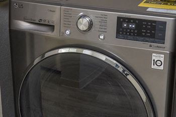 a stainless steel washer & dryer combo unit in an apartment at Terraces at Clearwater Beach