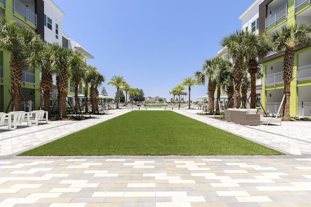 Green lawn area leading to pool at Residences at The Green in Lakewood Ranch, FL