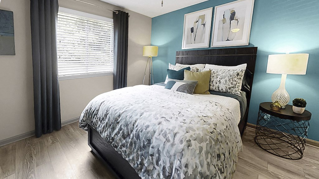 Bedroom with large window, plank-style floor, and model furnishings at The Madison Franklin, Tennessee