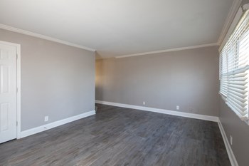 living room with wood-style flooring and large windows living room with wood-style flooring and large windows at The Kensington Apartments, Alabama - Photo Gallery 4