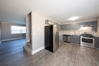 open kitchen with stainless steel appliances and wood-style floors open kitchen with stainless steel appliances and wood-style floors at The Kensington Apartments, Huntsville, Alabama - Photo Gallery 6