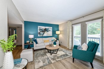 Berry-Living2 living room with accent wall, model furnishings, and large sliding glass doors to patio - Photo Gallery 5