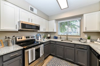 Jameson-Kitchen2 kitchen with white cabinets, stainless steel appliances, and granite countertop - Photo Gallery 2