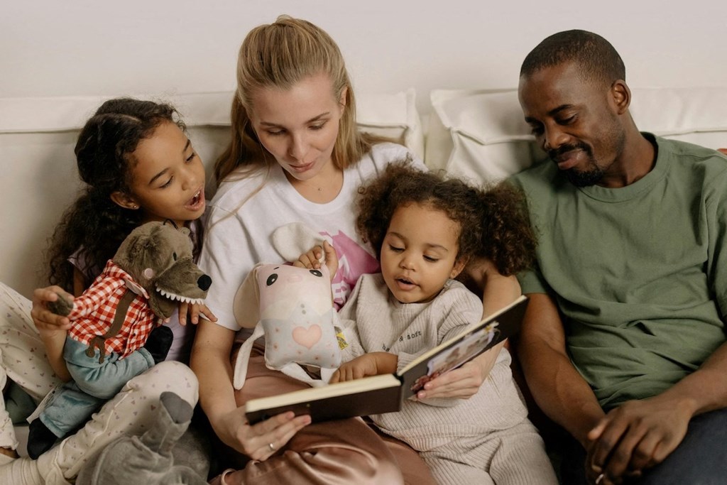 Waterview-Gallery-1 a family sitting on a couch reading a book to their children