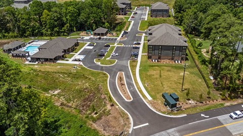 an aerial view of a neighborhood with houses and a road