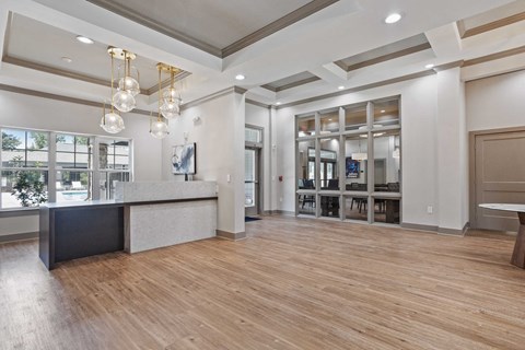 a lobby with a reception desk and a large window