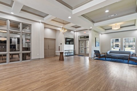 a large living room with a hard wood floor and windows