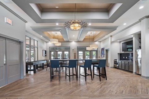 a large dining room with a large table and chairs