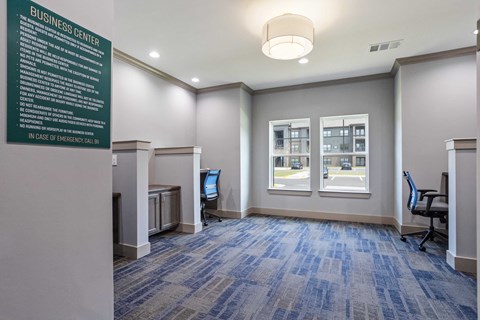 a conference room with a chalkboard and desks and chairs