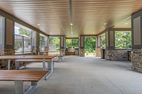 the gathering space is filled with benches and tables