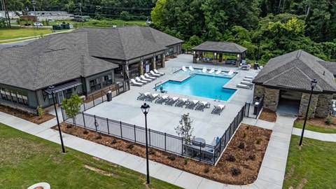 an aerial view of a resort style pool with lounge chairs