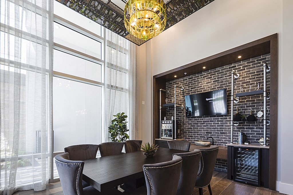 wine room Wine tasting room with wine chandelier, tv, and table with chairs at Residences at The Green in Lakewood Ranch, FL