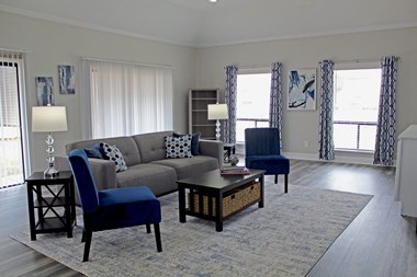 comfortable seating, large windows, and a coffee table in the office at Woodland Villas Apartments