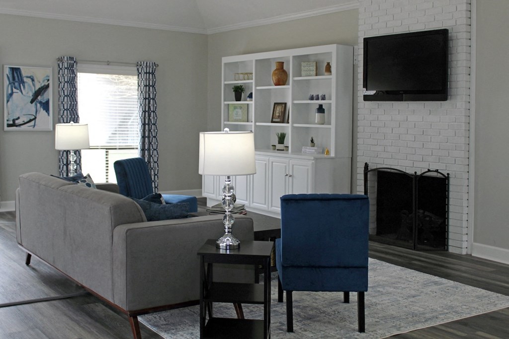 Office at Woodland Villas Apartments with plush furnishings, a fireplace, and bookcase with decor at Woodland Villas Apartments, Jasper, AL