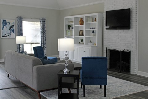 Office at Woodland Villas Apartments with plush furnishings, a fireplace, and bookcase with decor at Woodland Villas Apartments, Jasper, AL