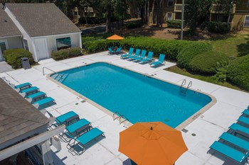 Zelda-Pointe-Gallery-13 rows of lounge chairs, picnic tables with umbrellas, and pool at Zelda Pointe Apartments - Photo Gallery 2