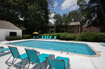 Zelda-Pointe-Gallery-12 rows of lounge chairs surrounding sparkling pool on sunny day - Photo Gallery 5