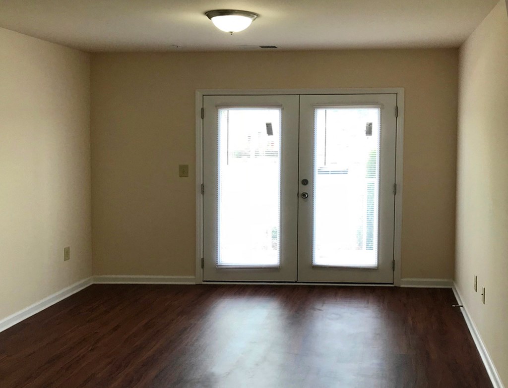 living room with hardwood-style floors and french doors
