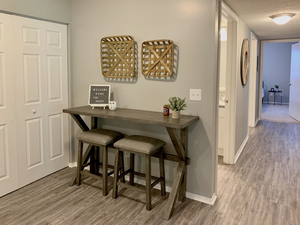 nook with small table and stools by laundry closet