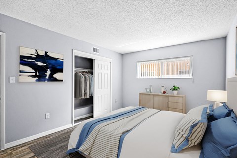 A bedroom with a bed, nightstand, and a painting on the wall.