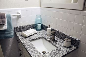 a bathroom with a sink and a mirror  at Huntsville Landing Apartments, Huntsville, AL, 35806