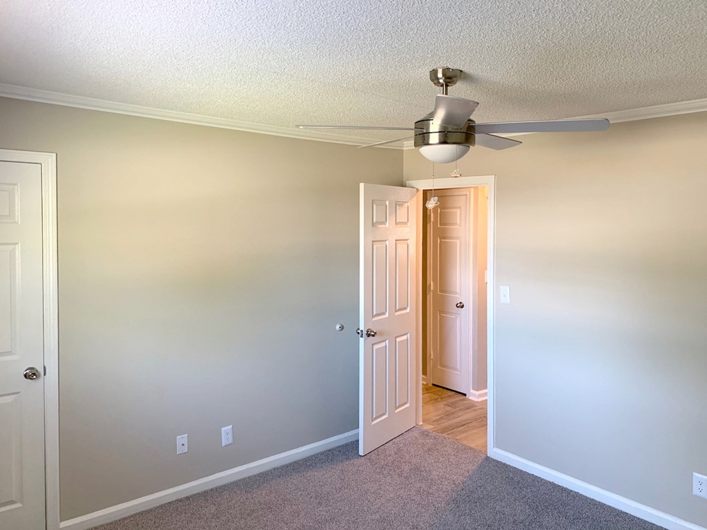 bedroom with illuminated ceiling fan kit, plush carpeting, and natural light