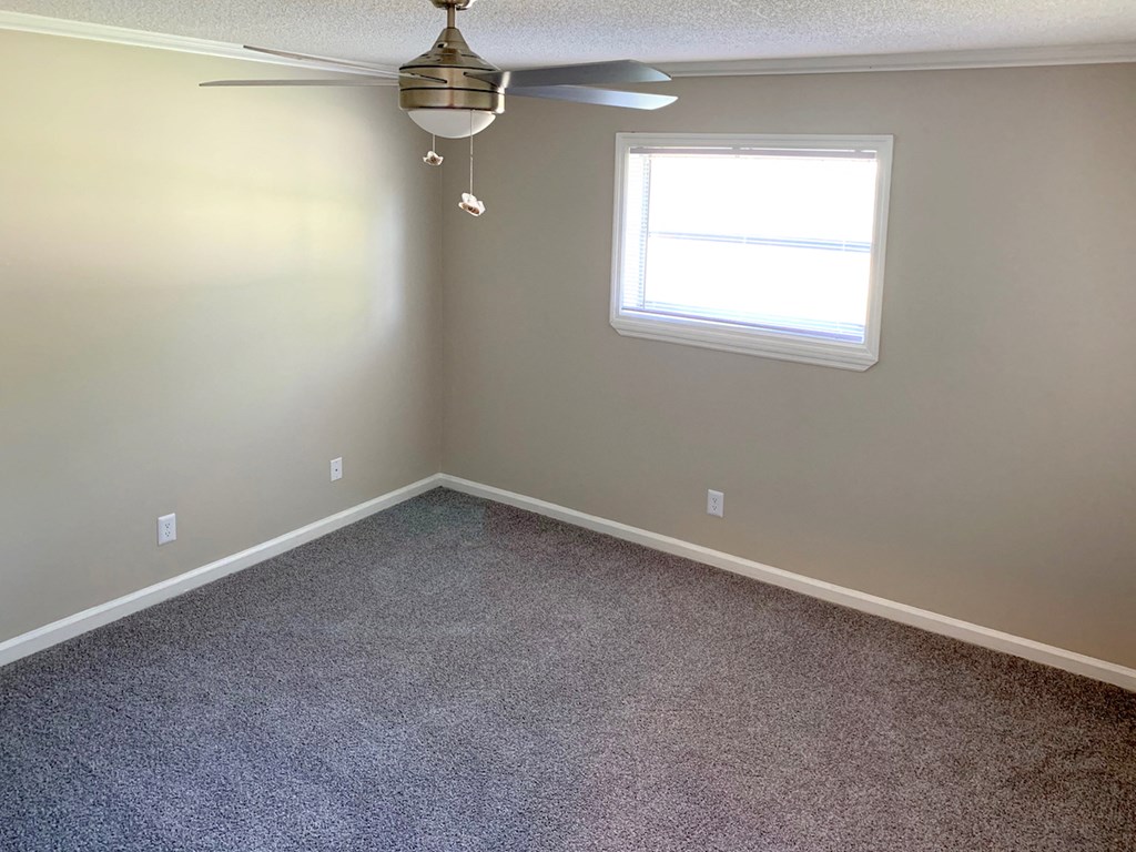 bedroom with ceiling fan, plush carpeting, and window