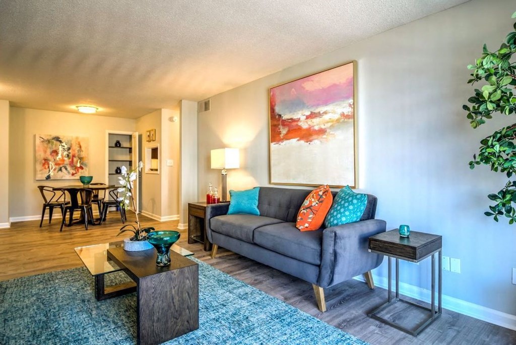 Living room with wood-style flooring, dining area and model furnishings