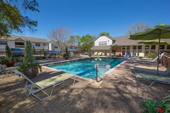 Pool and sundeck with lounge chairs Pool and sundeck with lounge chairs at Aspen Run and Aspen Run II Apartments, Tallahassee, Florida - Photo Gallery 3