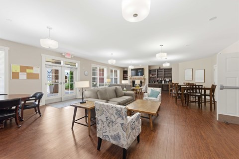 A spacious living room with a variety of furniture including a couch, chairs, and a coffee table.
