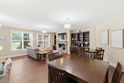 A dining room with a wooden table and chairs.at The Lodge at Johns Road Apartments, Huntsville, AL, 35806