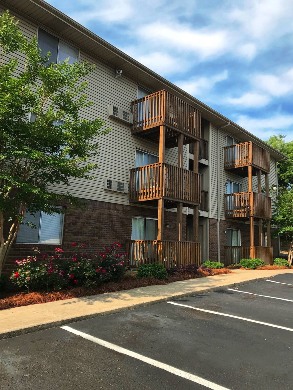 outside of southwood gardens apartments with large resident parking lot