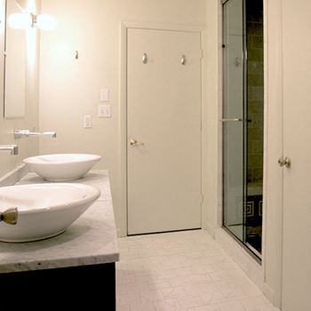 modern bathroom with bowl sinks and tile floors at Goodall-Brown Lofts, Birmingham, 35203