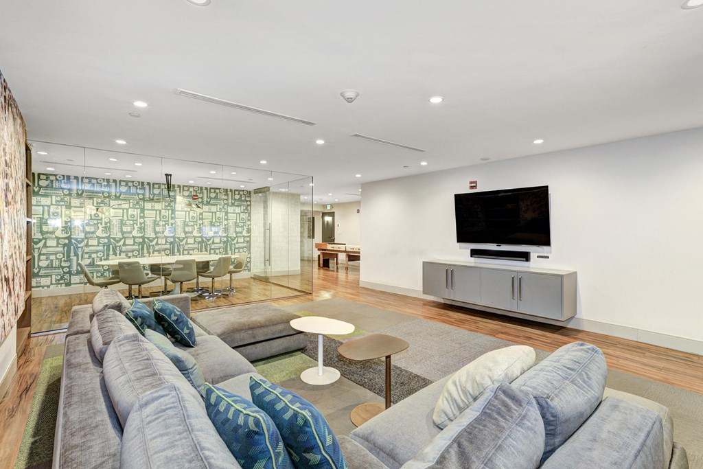 a living room filled with furniture and a flat screen tv