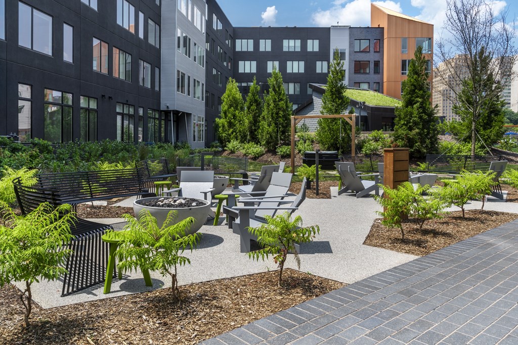 a courtyard with seating and a fire pit at the axis at walnut creek apartments