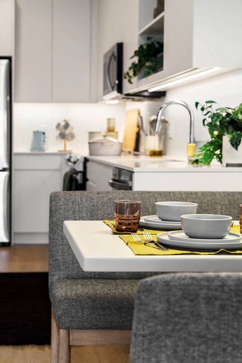 a kitchen with a table with plates and cups on it