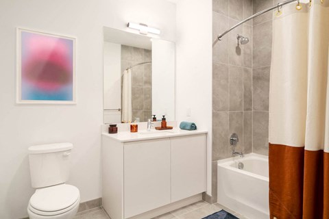 a bathroom with a toilet sink and a shower