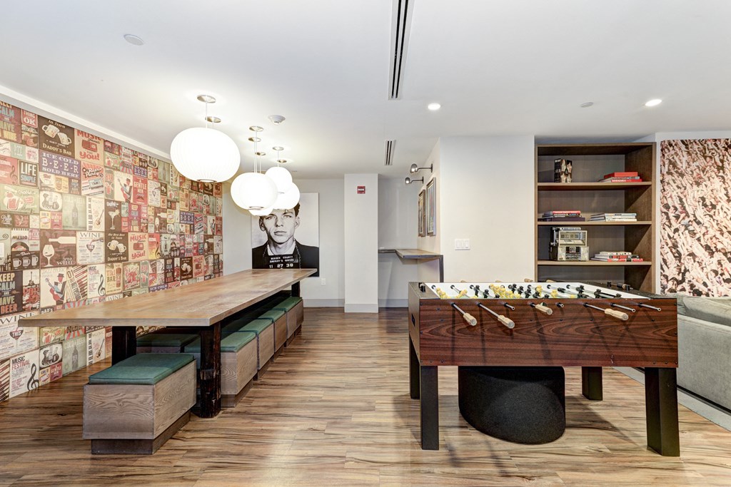 a room filled with furniture and a large mural of a man on a wall