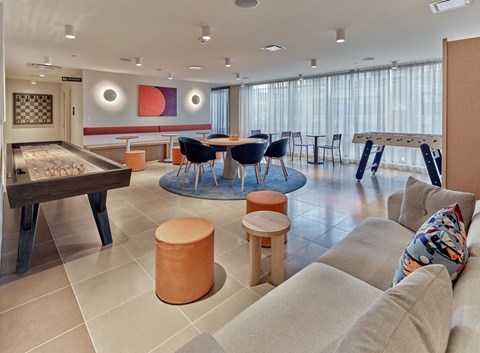 a living room with a pool table and a couch