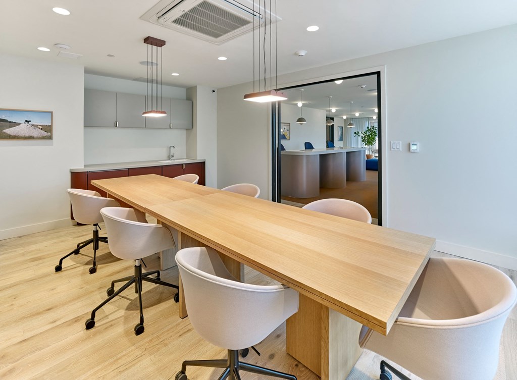a conference room with a wooden table and chairs