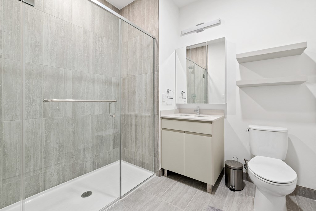 a bathroom with a shower toilet and sink