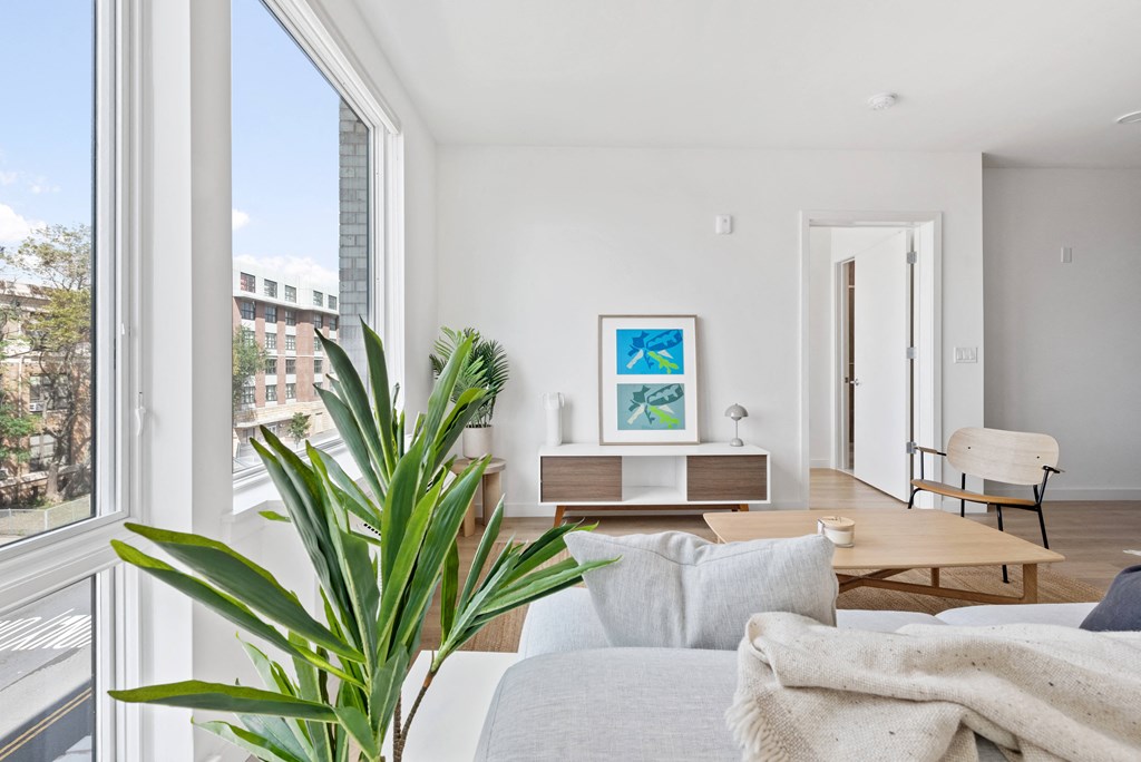 a living room with a couch and a table and a large window