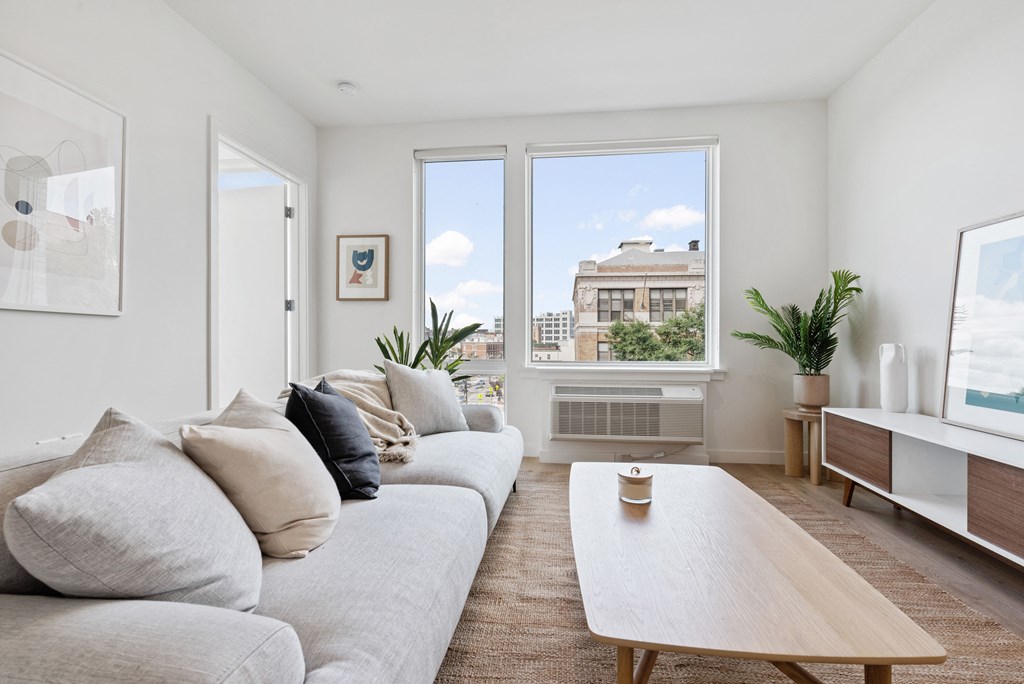a living room with a couch and a table and a window